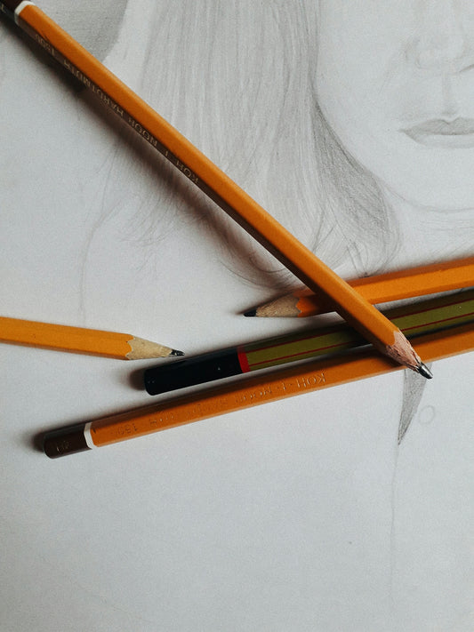 brown and black pencil on white paper