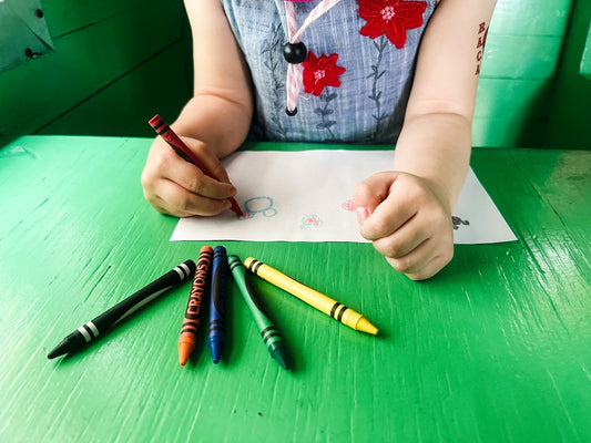 a child drawing with scissors