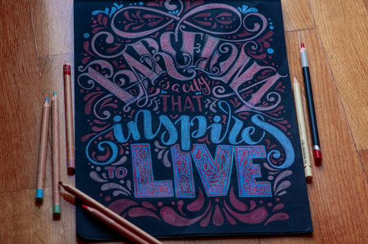 a drawing of a quote on a blackboard with colored pencils