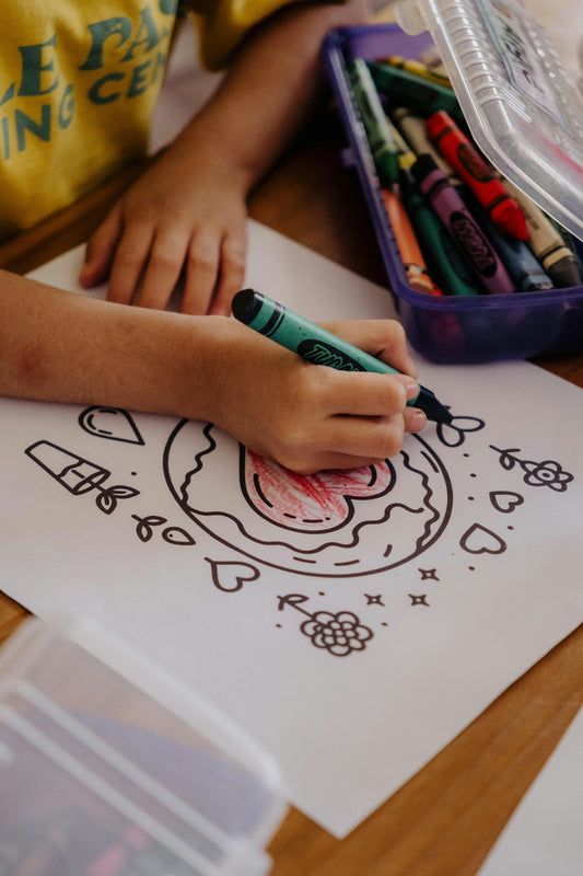 A child is drawing on a piece of paper