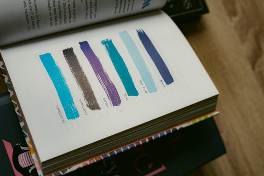 A stack of books sitting on top of a wooden table