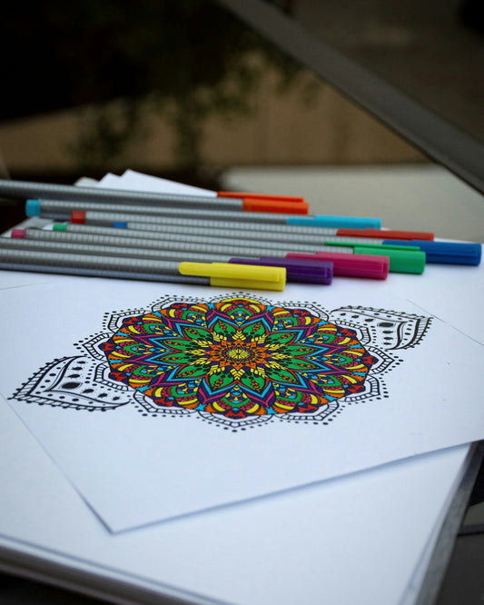 A picture of a coloring book with markers and pencils