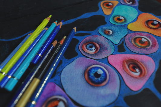 Colored pencils and abstract eyes drawing