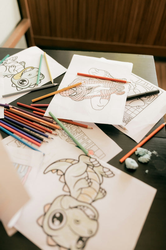 Coloring pages with crayons scattered on a table