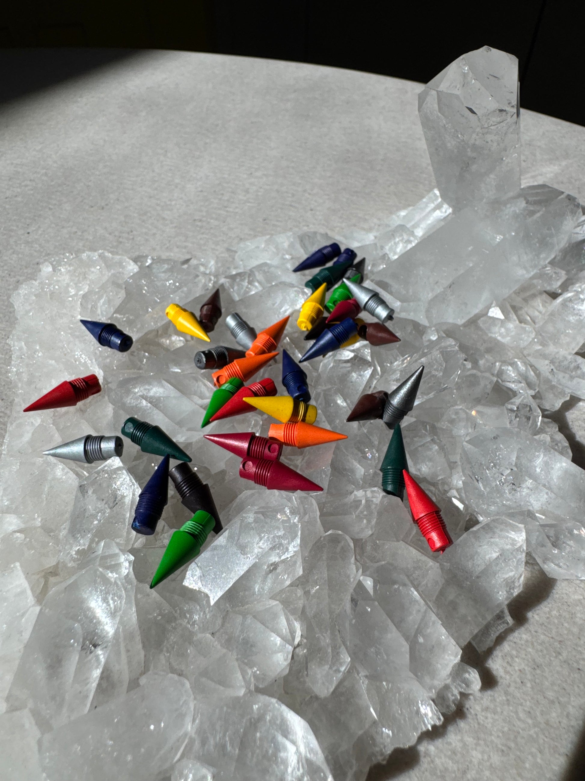 Colorful pencil nibs objects on a crystal surface